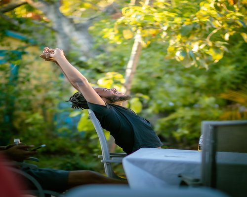 mature man stretching arms outdoor during a sunny day